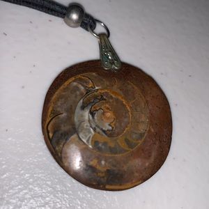 Pendant necklace: Brown stone/fossil, black cloth cord, silver-tone hardware